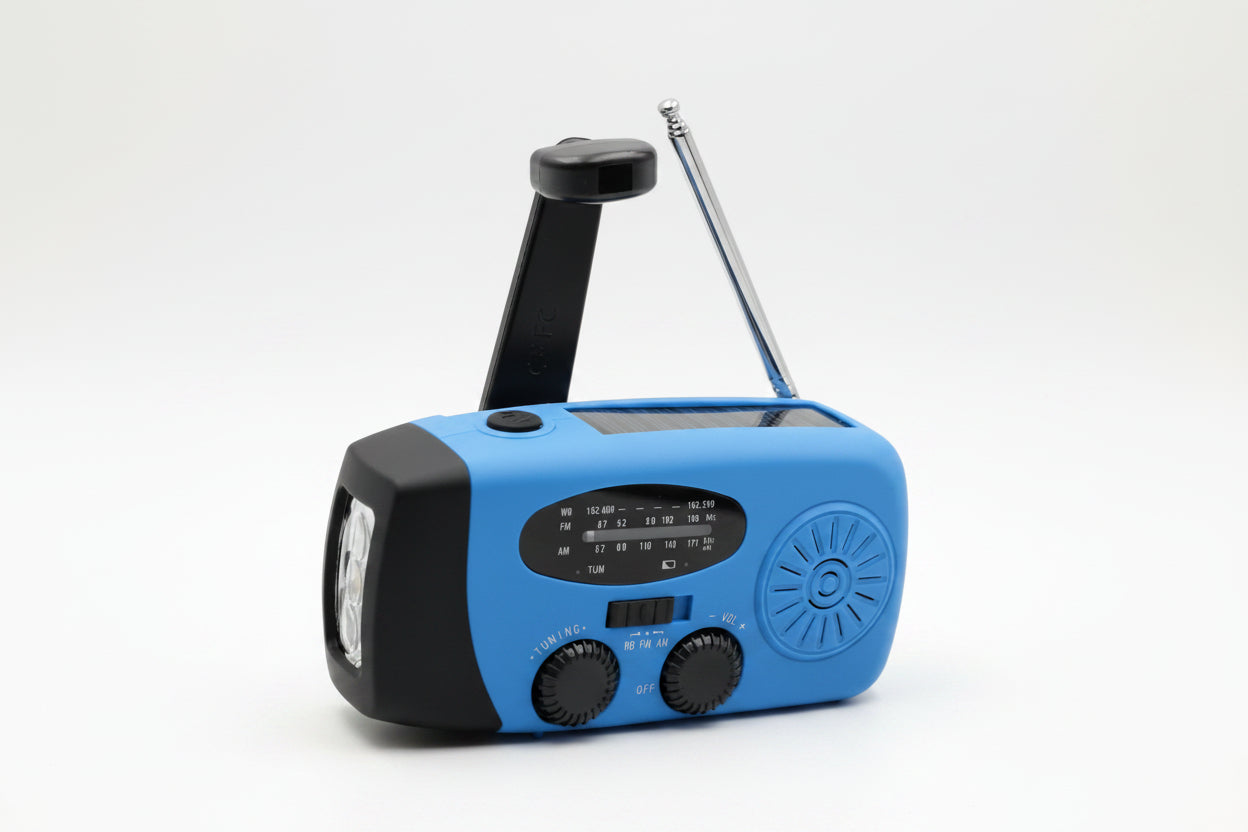 Blue and black portable radio with flashlight on a gray background